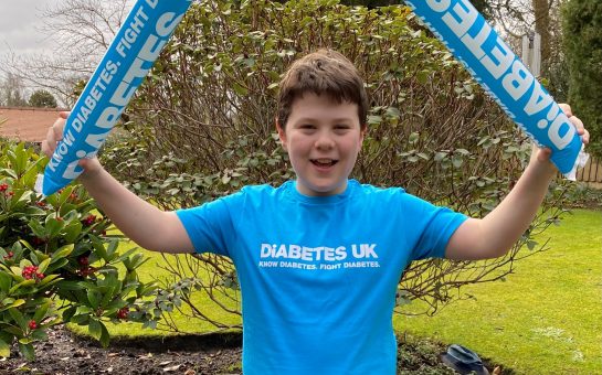 Malachy Hatton, wearing a Diabetes UK t-shirt, is triumphant after completing his run