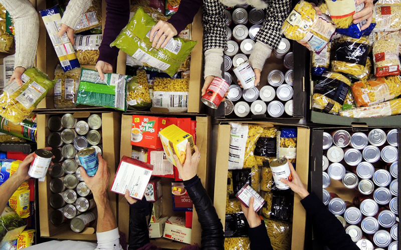 Volunteers sorting food items at a food bank