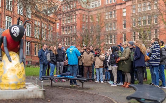 A photograph of Josh Martin, founder of Manchester's original free walking tour, leading a tour group