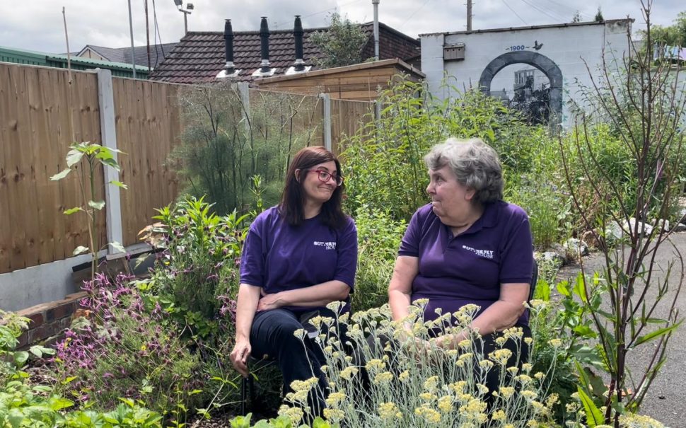 Volunteers smiling in the garden