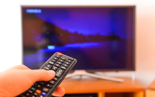 a remote in front of a blurred TV