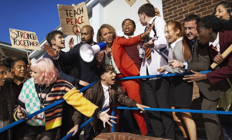 A publicity image from the new series of Waterloo Road. Students are protesting, and the headteacher is trying to keep them under control.