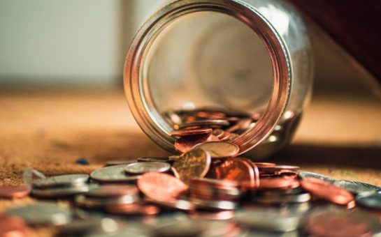 Coins spilling out of a jar