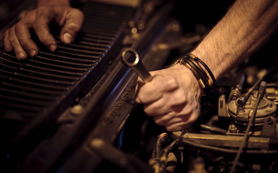mechanic working on a car engine