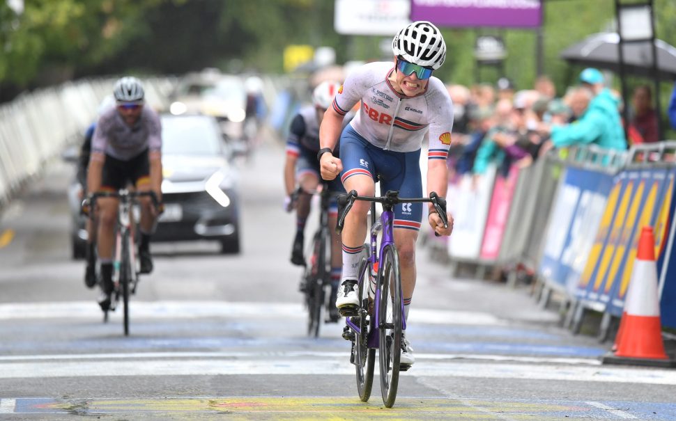 Archie Atkinson cycling across the finish line