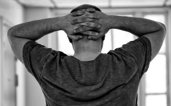 Black and white stock photo of back if male head and hands