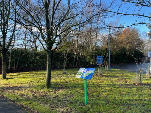 Sign on grassy area in green health walk