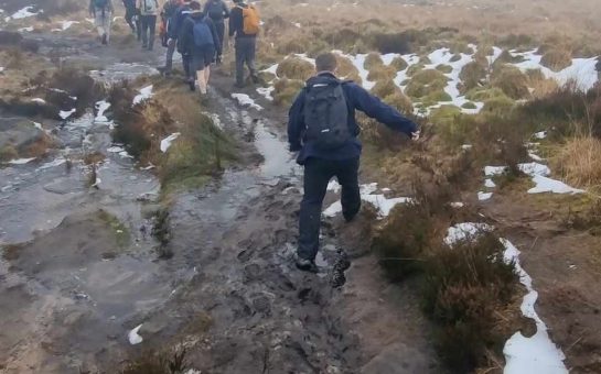 Photo of several men walking in the Peak District