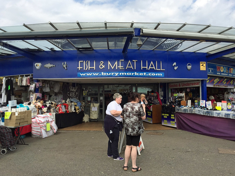 Bury Market Fish and Meat Hall entrance with three people outside