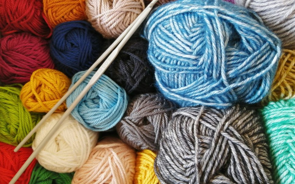 Many balls of yarn and knitting needles
