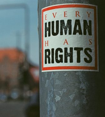 Sticker on a post, with 'Every human has rights' By Markus Spiske