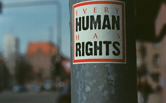 Sticker on a post, with 'Every human has rights' By Markus Spiske