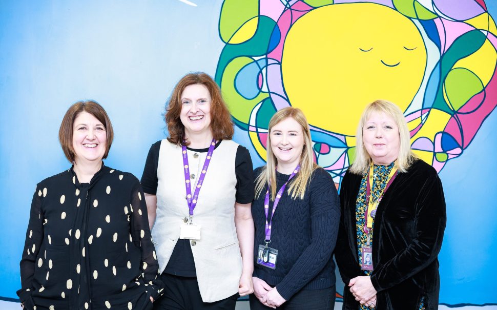 Group of women smiling for new charity scheme.