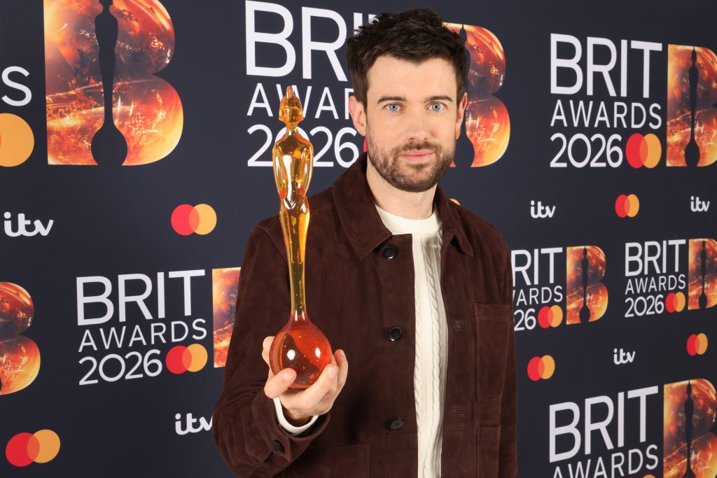Jack Whitehall holding trophy.
