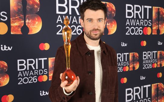 Jack Whitehall holding trophy.