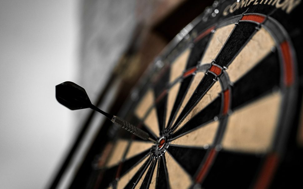 A dart in the bullseye of a dartboard (Credit: Free to use from Unsplash)